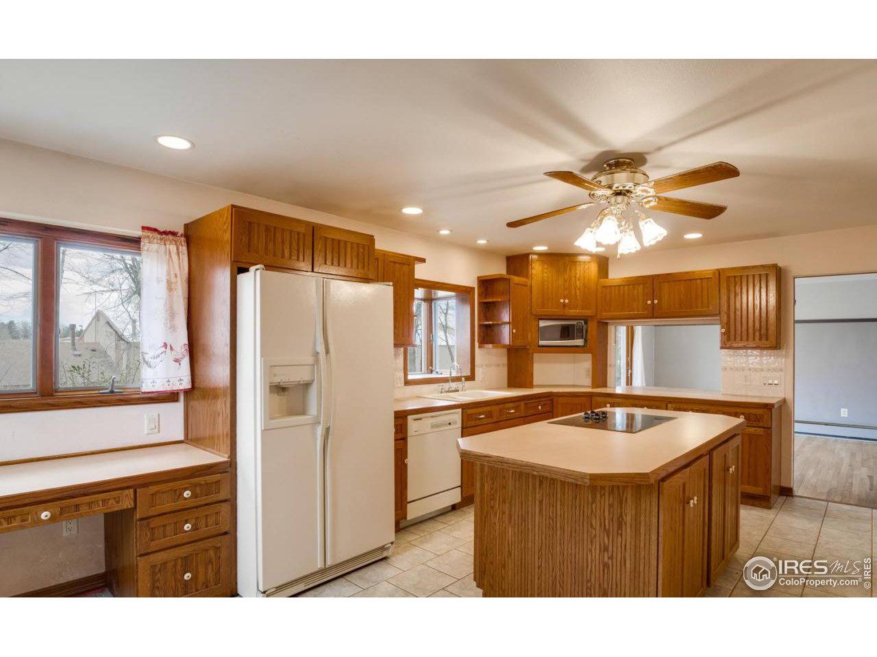 125 West Trilby Road Fort Collins, CO 80525 - Photo 9 of 26 a kitchen with stainless steel appliances granite countertop a sink and a refrigerator