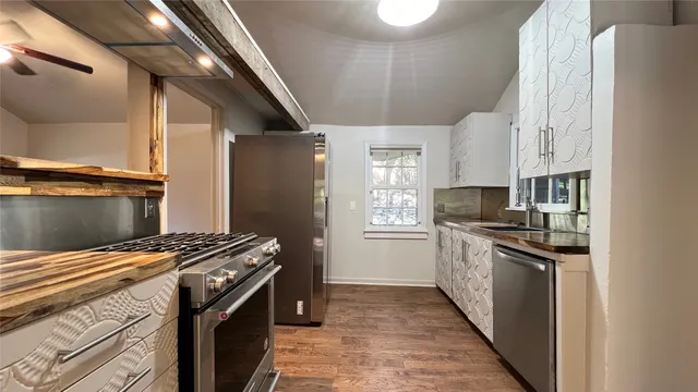 a kitchen with stainless steel appliances granite countertop a stove and a refrigerator