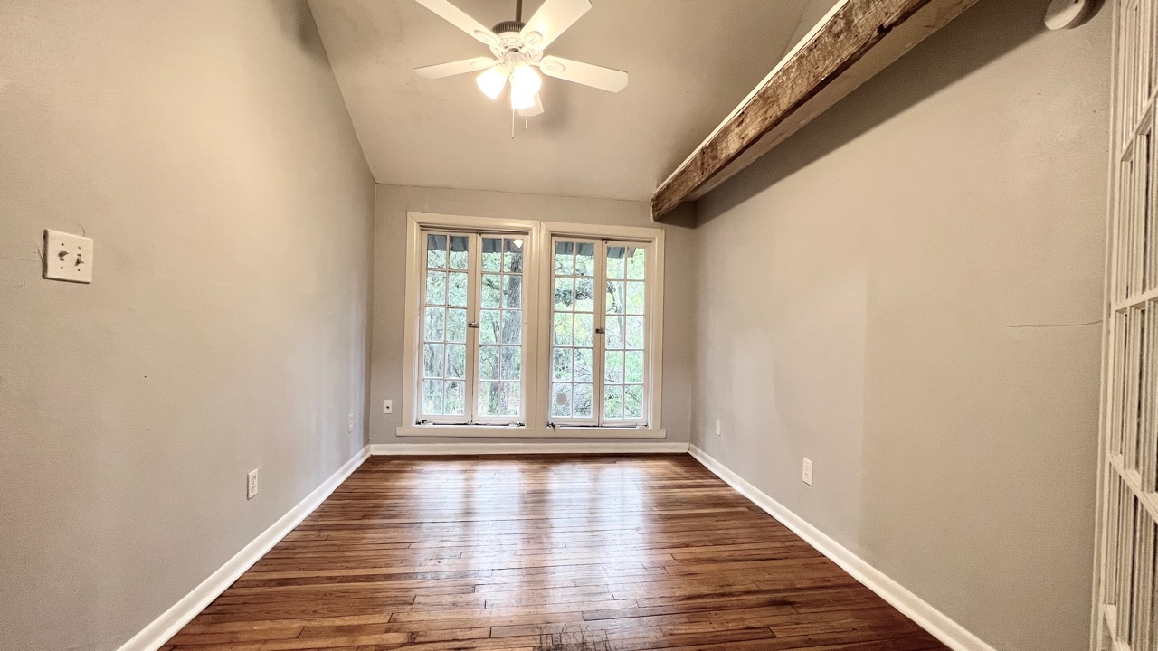 2104 West 7th Street Austin, TX 78703 - Photo 6 of 11 Unfurnished room with dark wood-style floors and ceiling fan