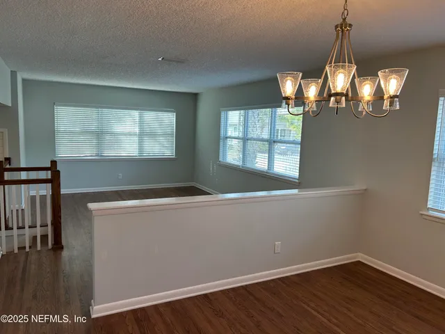 a kitchen with stainless steel appliances white cabinets a stove top oven a sink and dishwasher