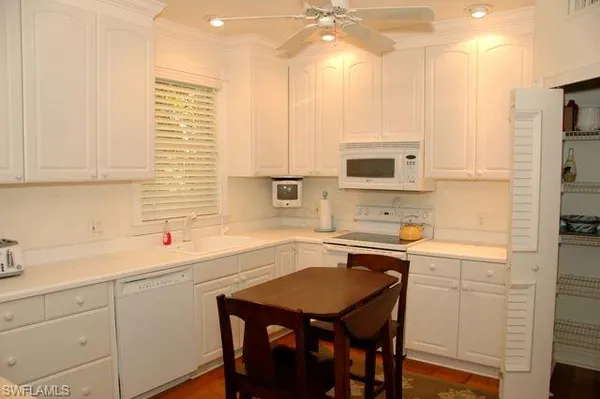 a kitchen with a sink cabinets and window