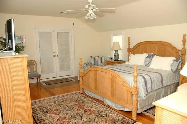 a spacious bedroom with a bed and a chandelier
