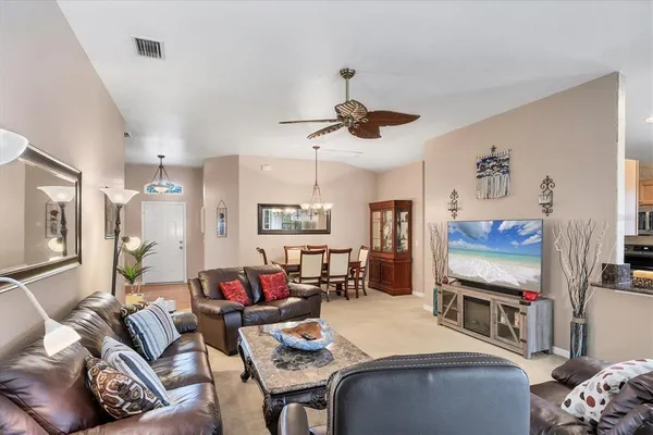 a kitchen with granite countertop a stove a sink dining table and chairs