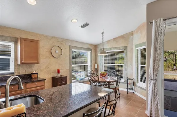 a kitchen with stainless steel appliances granite countertop sink stove and cabinets
