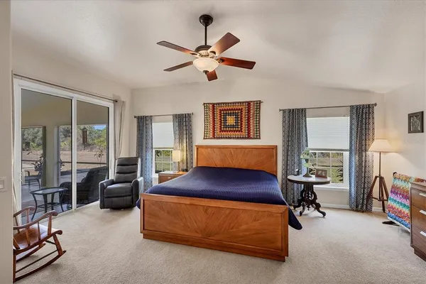 a view of a livingroom with furniture and a ceiling fan