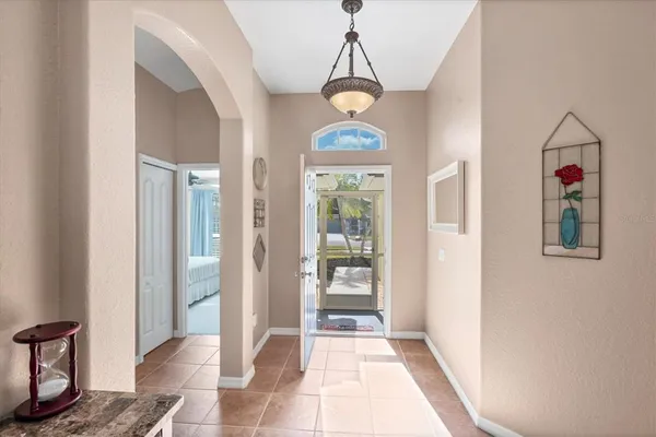a view of a dining room and livingroom with furniture wooden floor a chandelier