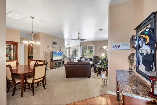 a living room with furniture a fireplace and a large window