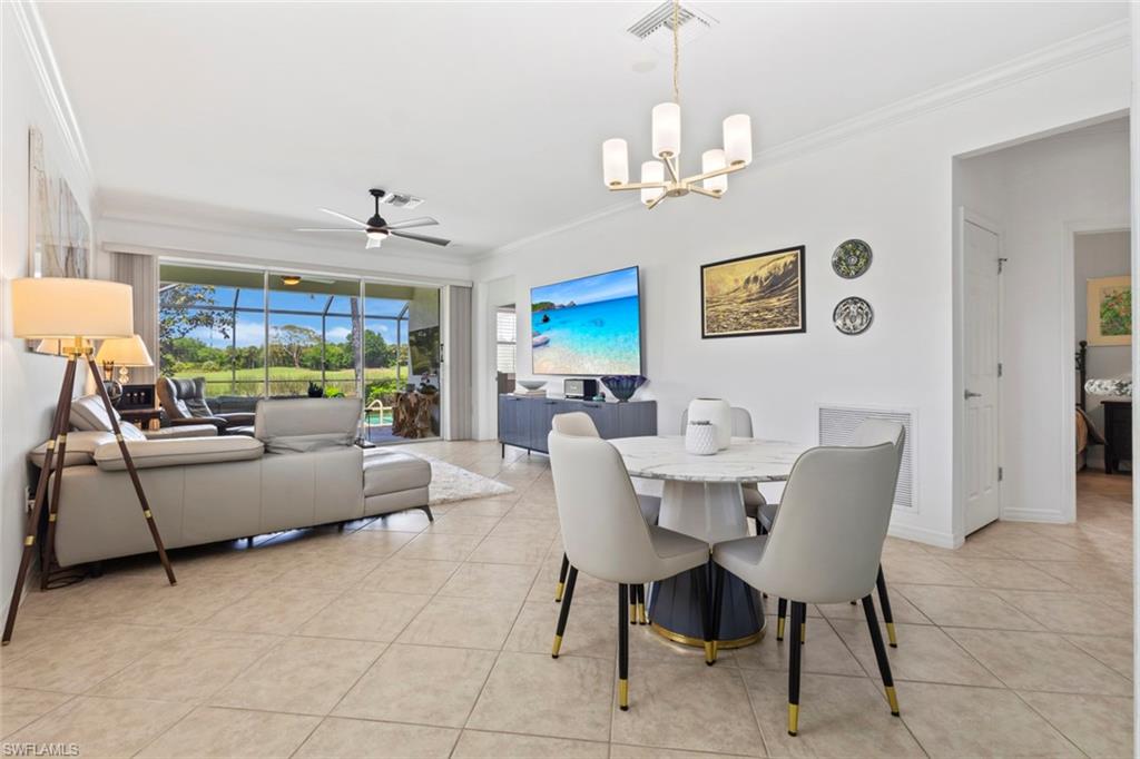 5719 Declaration Court Ave Maria, FL 34142 - Photo 16 of 48 a living room with furniture a chandelier and a dining table
