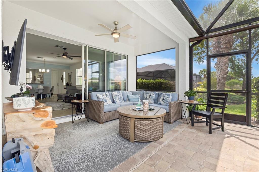 5719 Declaration Court Ave Maria, FL 34142 - Photo 24 of 48 a living room with furniture and a floor to ceiling window