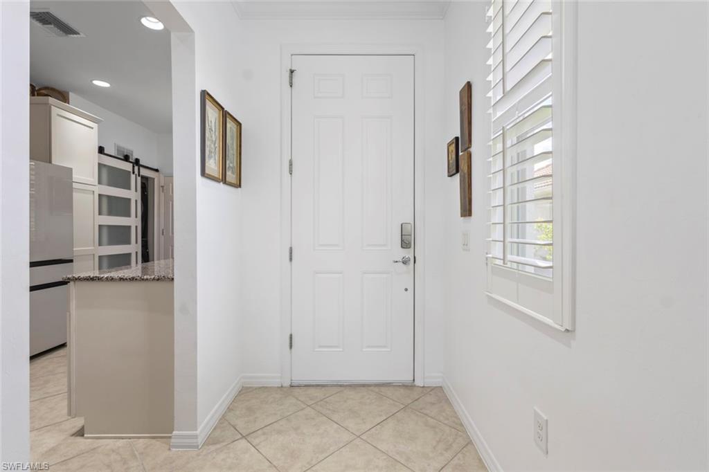 5719 Declaration Court Ave Maria, FL 34142 - Photo 31 of 48 a view of a hallway with wooden floor and a living room