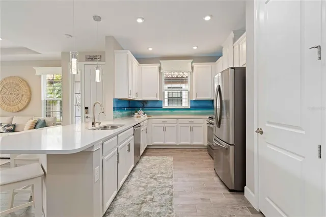 an aerial view of a house with swimming pool and ocean view