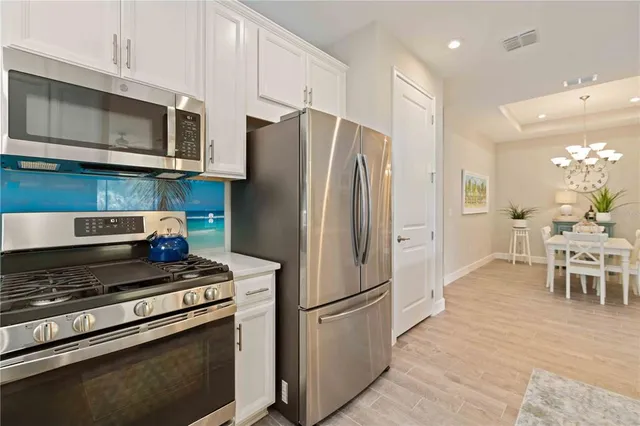 a view of a swimming pool with a chair and palm trees