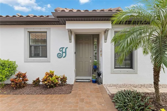 a dining room with furniture a chandelier and wooden floor