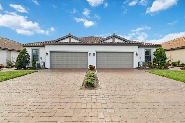 a dining room with furniture a chandelier and wooden floor