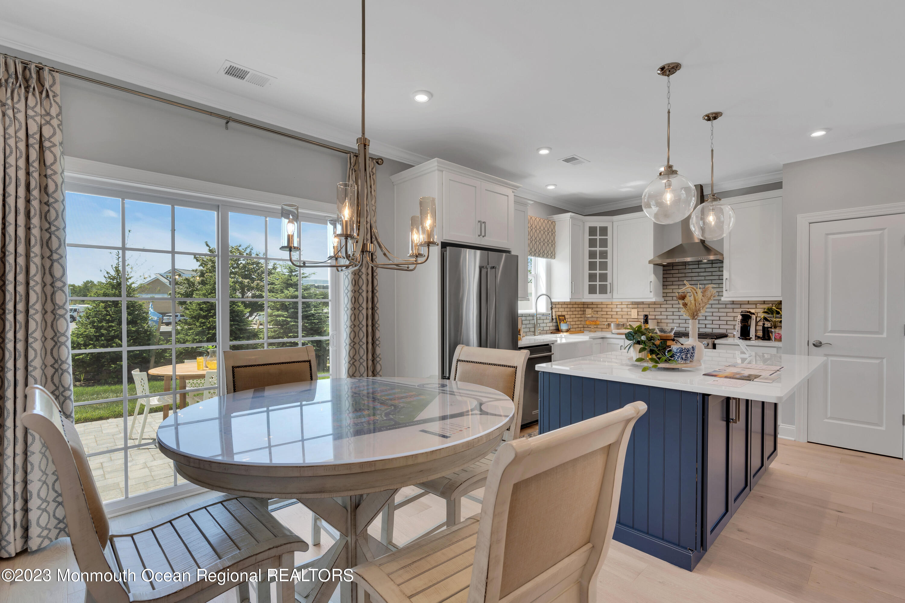 22 Chapel Lane Neptune, NJ 07753 - Photo 4 of 30 a kitchen with kitchen island a large window in it and stainless steel appliances