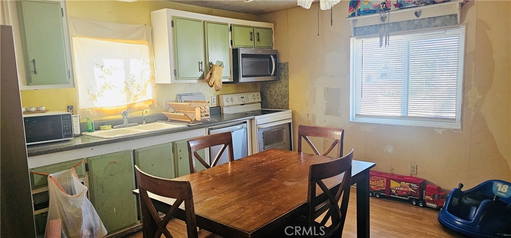 20683 Waalew Road, Unit B145 Apple Valley, CA 92307 - Photo 2 of 32 a dining room with furniture and window