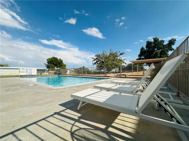 a view of swimming pool with outdoor seating and plants