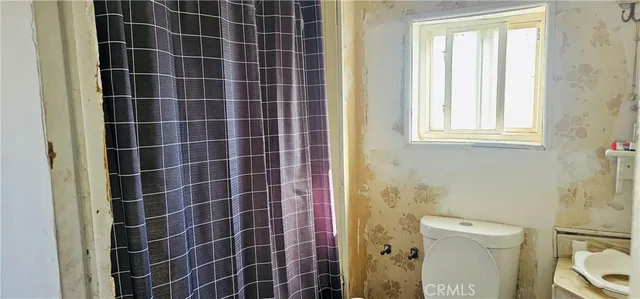 a bathroom with a sink a toilet and a shower