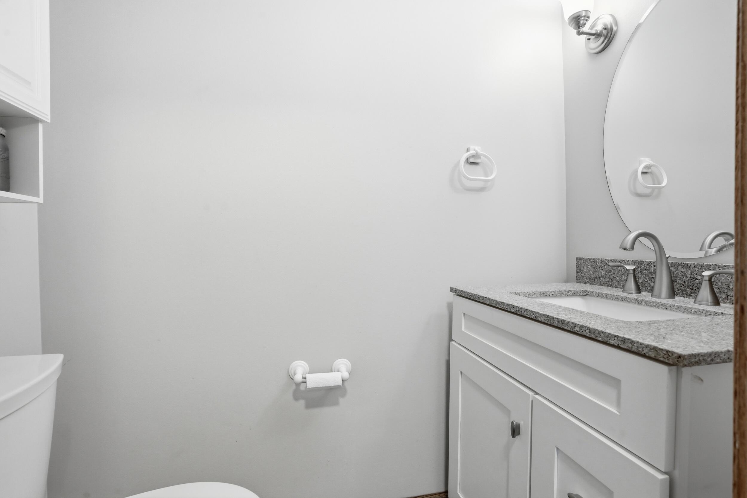1122 Douglas Lane Crete, IL 60417 - Photo 12 of 28 a bathroom with a granite countertop sink and mirror