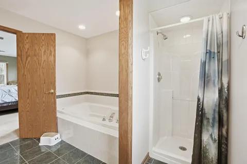 a bedroom with a bed a dresser and a window