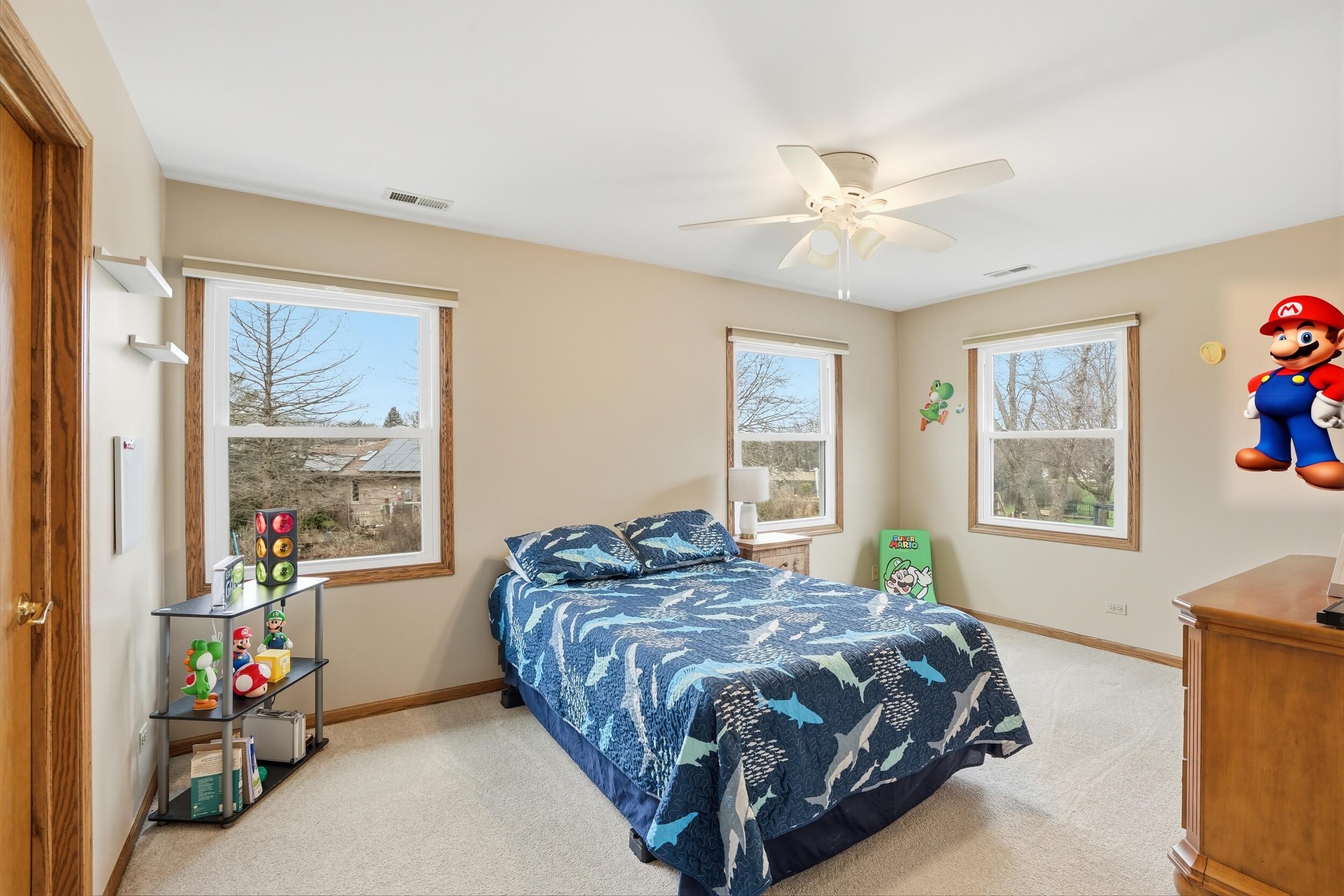 1122 Douglas Lane Crete, IL 60417 - Photo 16 of 28 a bedroom with a bed a dresser and a window