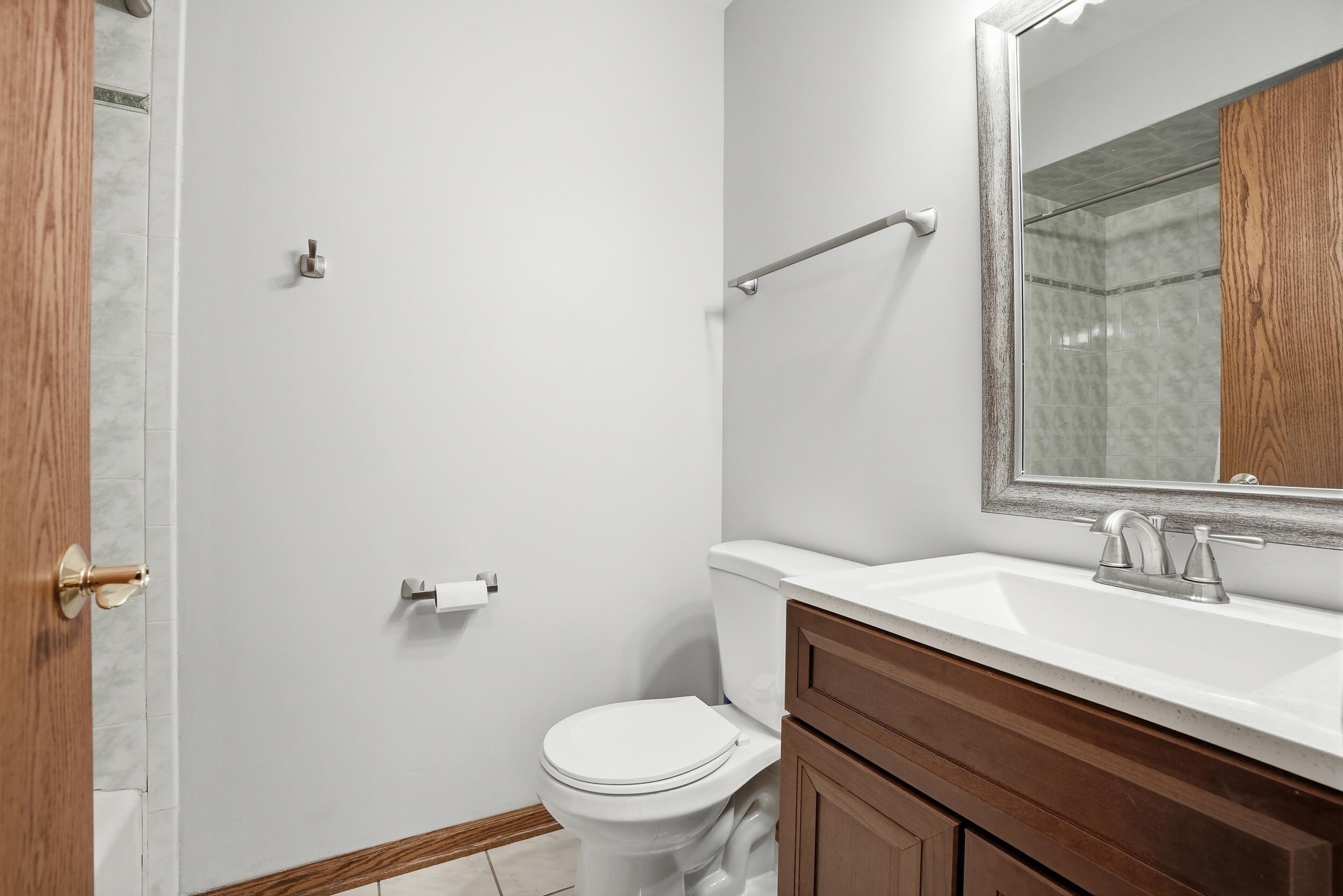 1122 Douglas Lane Crete, IL 60417 - Photo 17 of 28 a bathroom with a sink a toilet and shower
