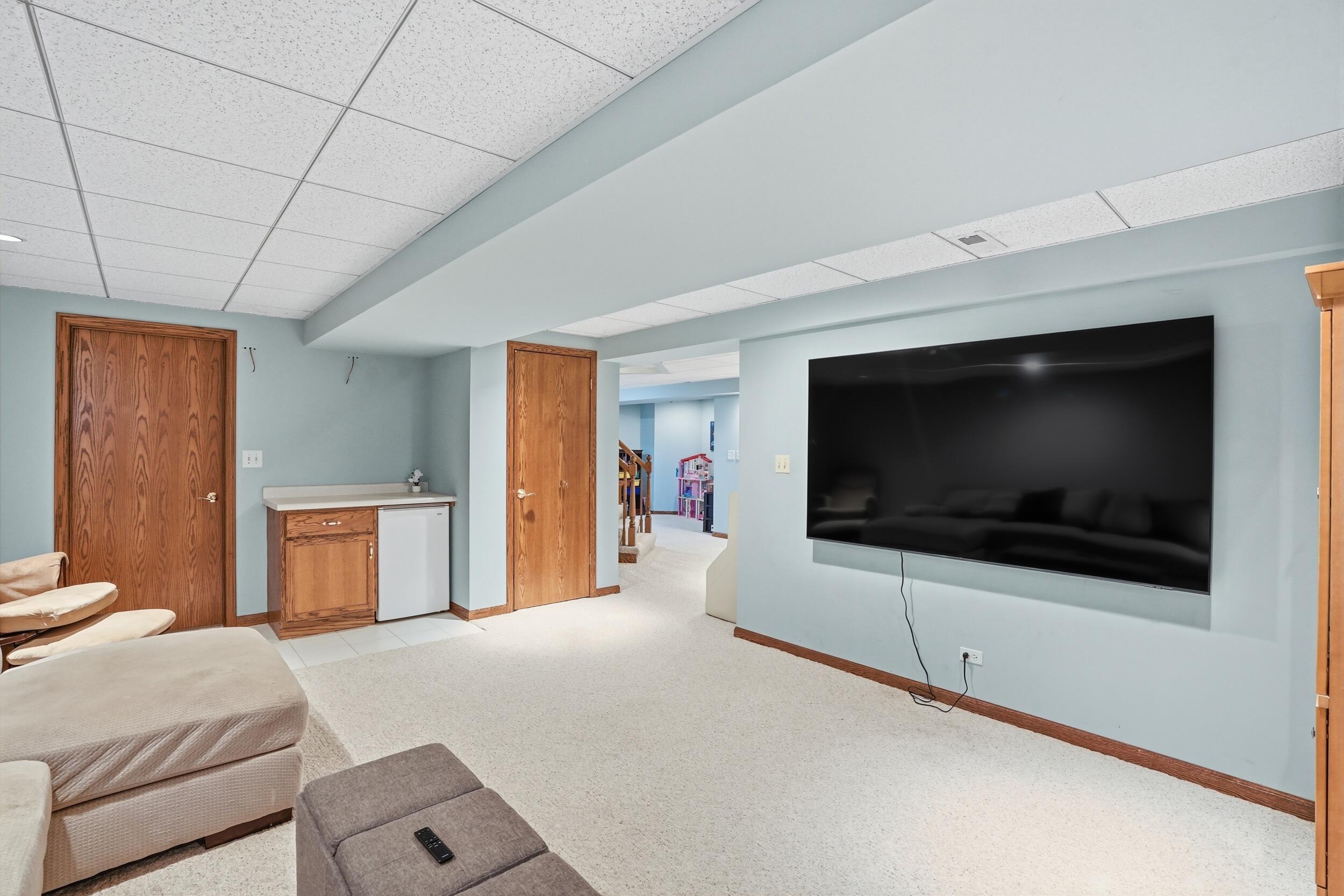1122 Douglas Lane Crete, IL 60417 - Photo 21 of 28 a bedroom with a bed and a flat screen tv