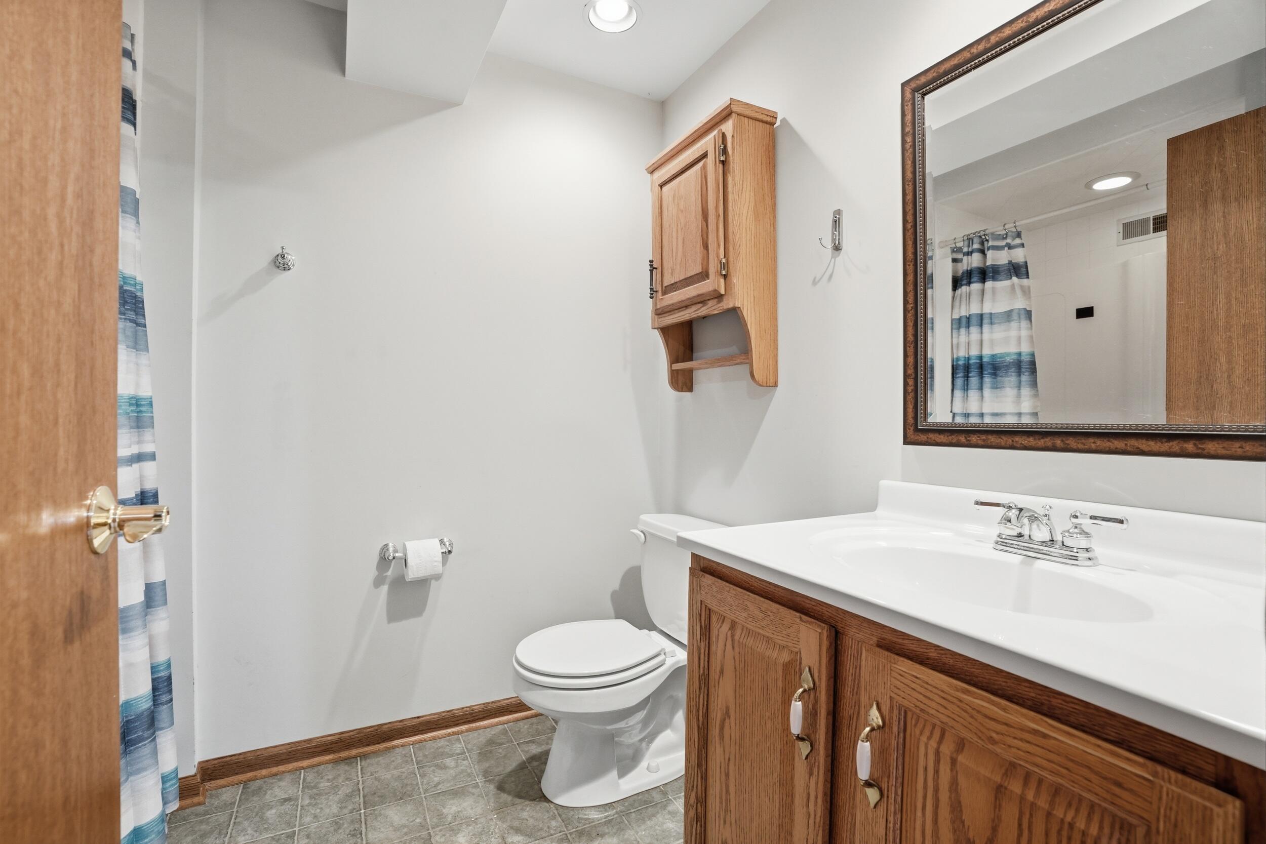 1122 Douglas Lane Crete, IL 60417 - Photo 23 of 28 a bathroom with a sink toilet and shower