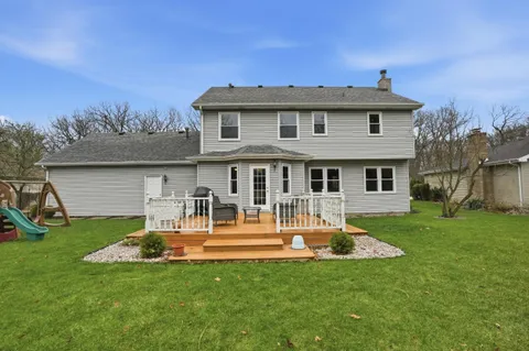 a view of a deck with couches table and chairs and wooden floor