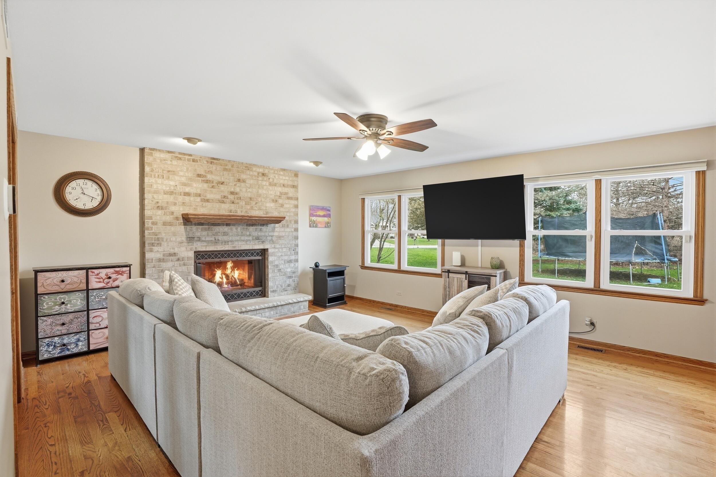 1122 Douglas Lane Crete, IL 60417 - Photo 10 of 28 a living room with furniture a fireplace and a flat screen tv