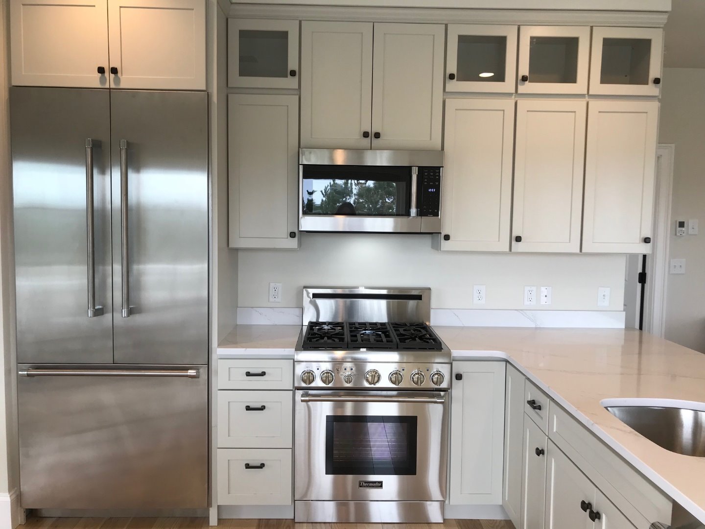 28 Beach Road Oak Bluffs, MA 02557 - Photo 11 of 32 a kitchen with stainless steel appliances granite countertop a stove a refrigerator and a sink with cabinets