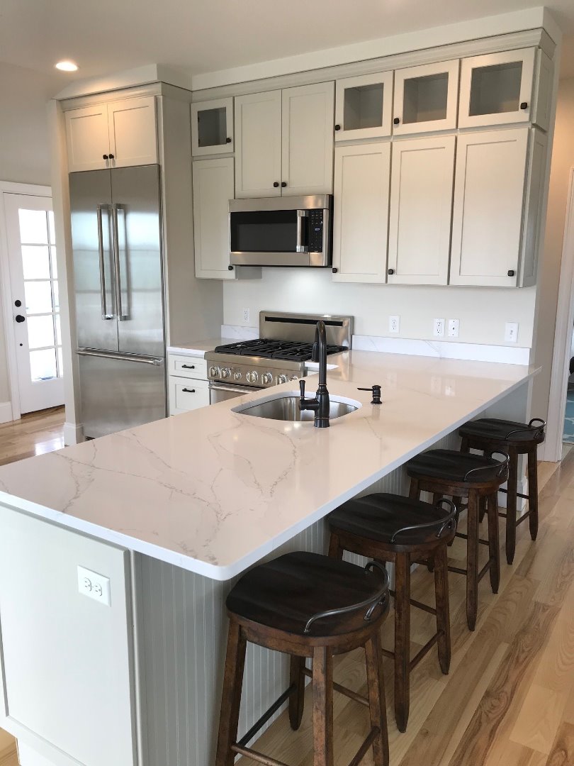 28 Beach Road Oak Bluffs, MA 02557 - Photo 12 of 32 a kitchen with stainless steel appliances a sink a stove a table and chairs