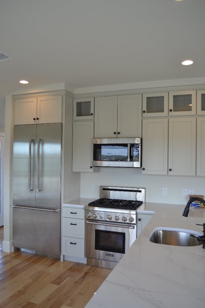 28 Beach Road Oak Bluffs, MA 02557 - Photo 14 of 32 a kitchen with granite countertop a sink and stainless steel appliances