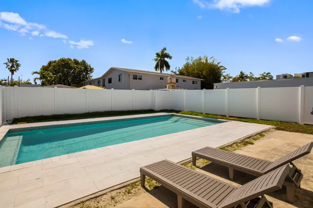 a view of a backyard with sitting area