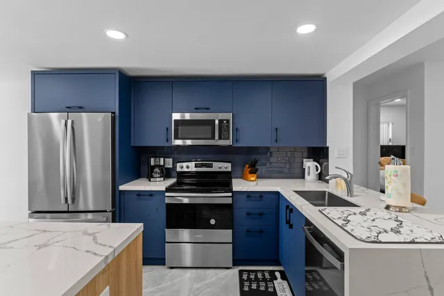 a living room with furniture and kitchen view