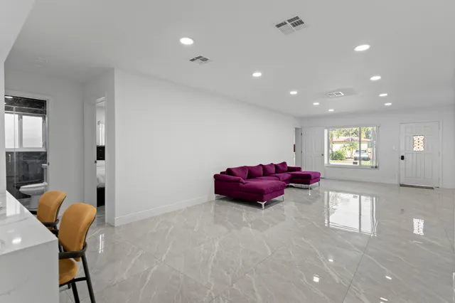 a bedroom with a bed and a large mirror