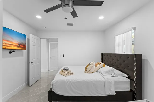 a bedroom with furniture and a flat screen tv