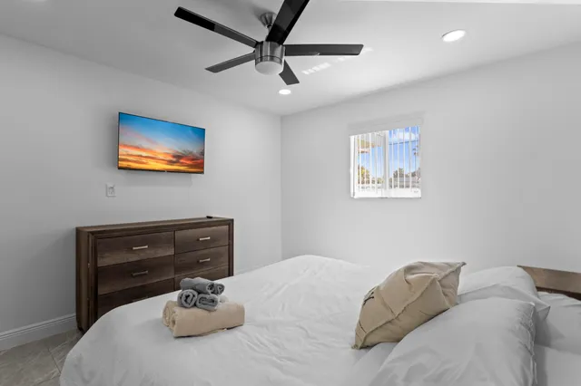 a bedroom with a bed and a window