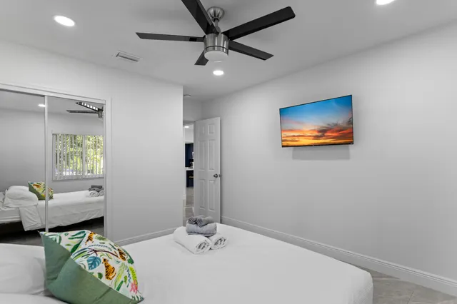 a bedroom with a bed and a chandelier