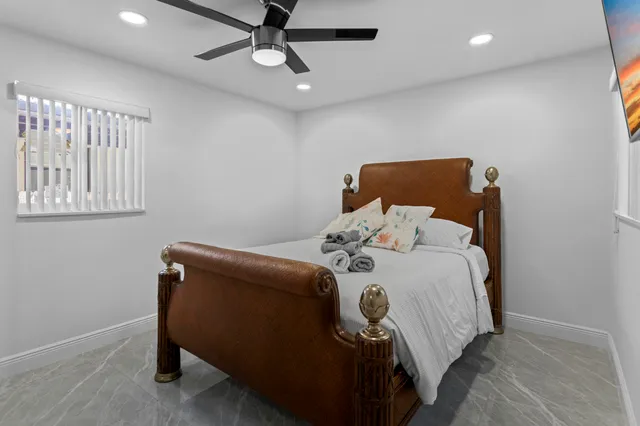 a bathroom with a shower sink vanity and toilet