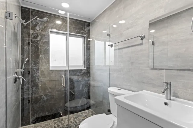 a bedroom with a bed and ceiling fan