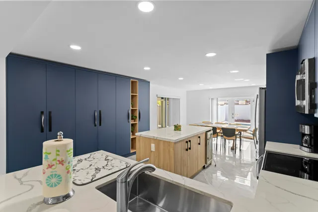 a kitchen with a table chairs stove and white cabinets