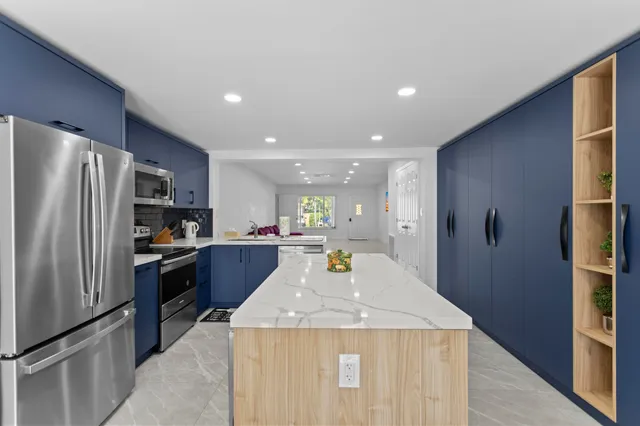 a kitchen with stainless steel appliances a refrigerator and a stove