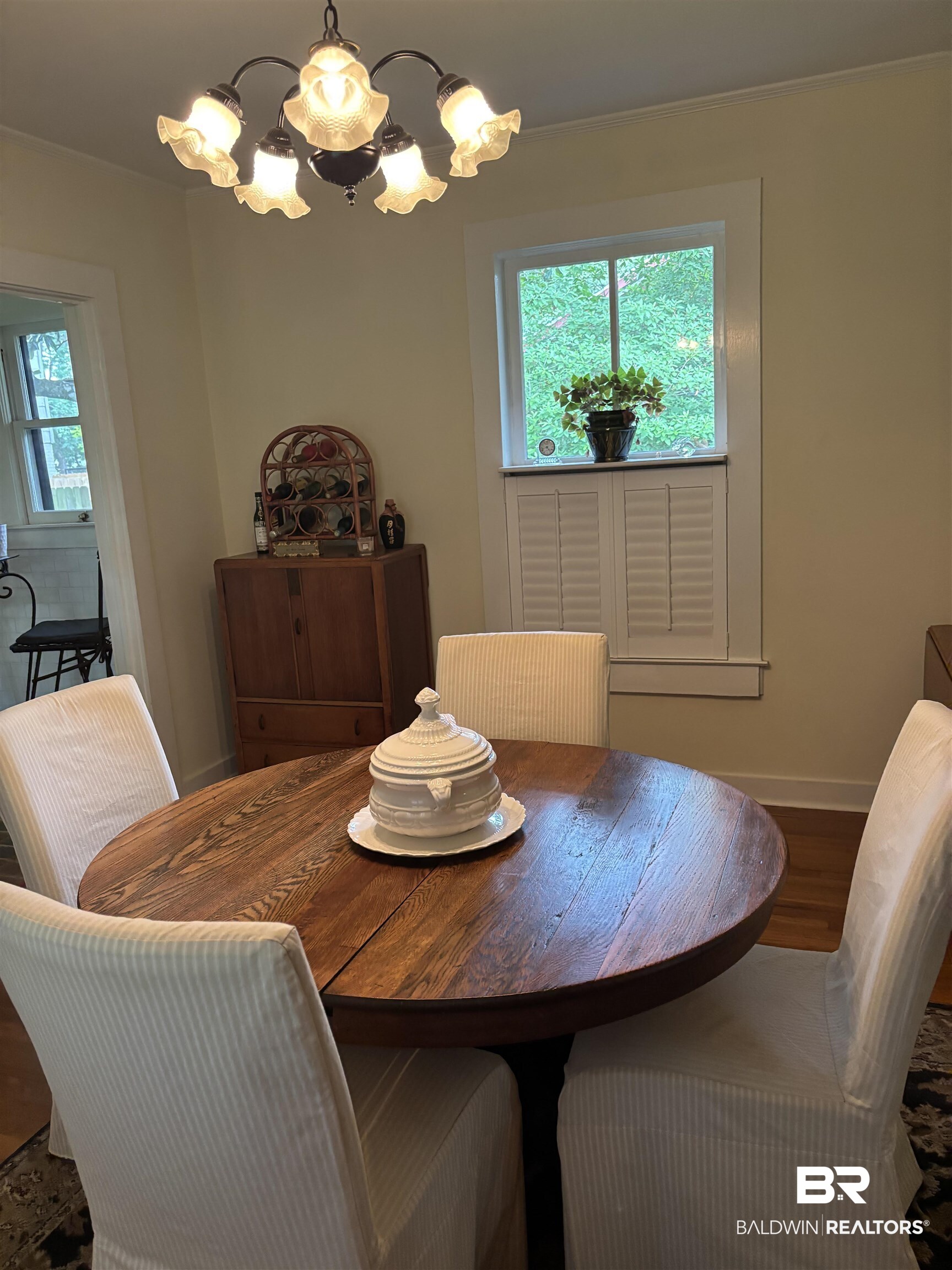 216 West Orange Avenue Foley, AL 36535 - Photo 20 of 37 Dining room with a chandelier, wood finished floors, and baseboards