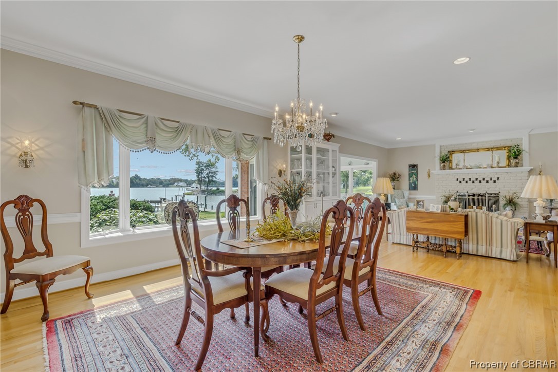 181 Duckbill Road White Stone, VA 22578 - Photo 20 of 50 Wood floored dining space with a chandelier and ornamental molding