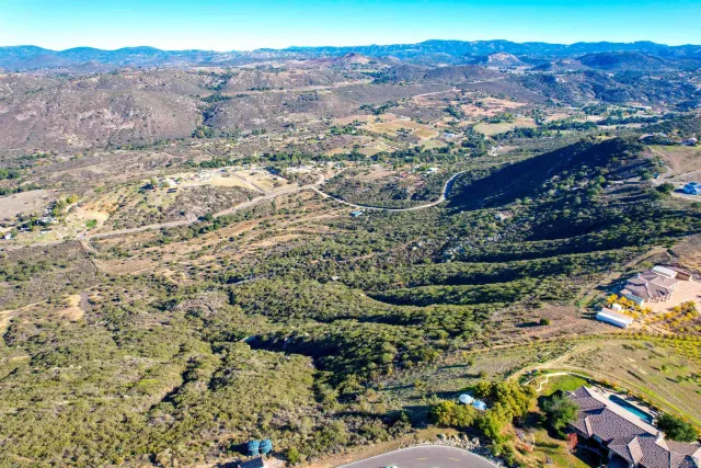 an aerial view of residential house and sandy dunes