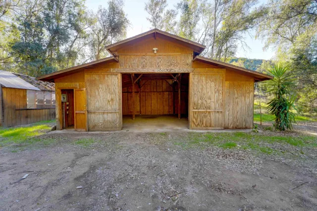 a backyard of a house with table and chairs