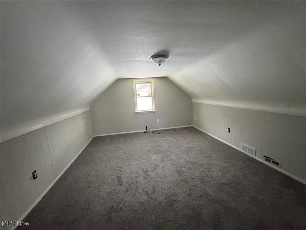 17002 Ridgeton Drive Cleveland, OH 44128 - Photo 18 of 19 Bonus room with vaulted ceiling, carpet, and baseboards
