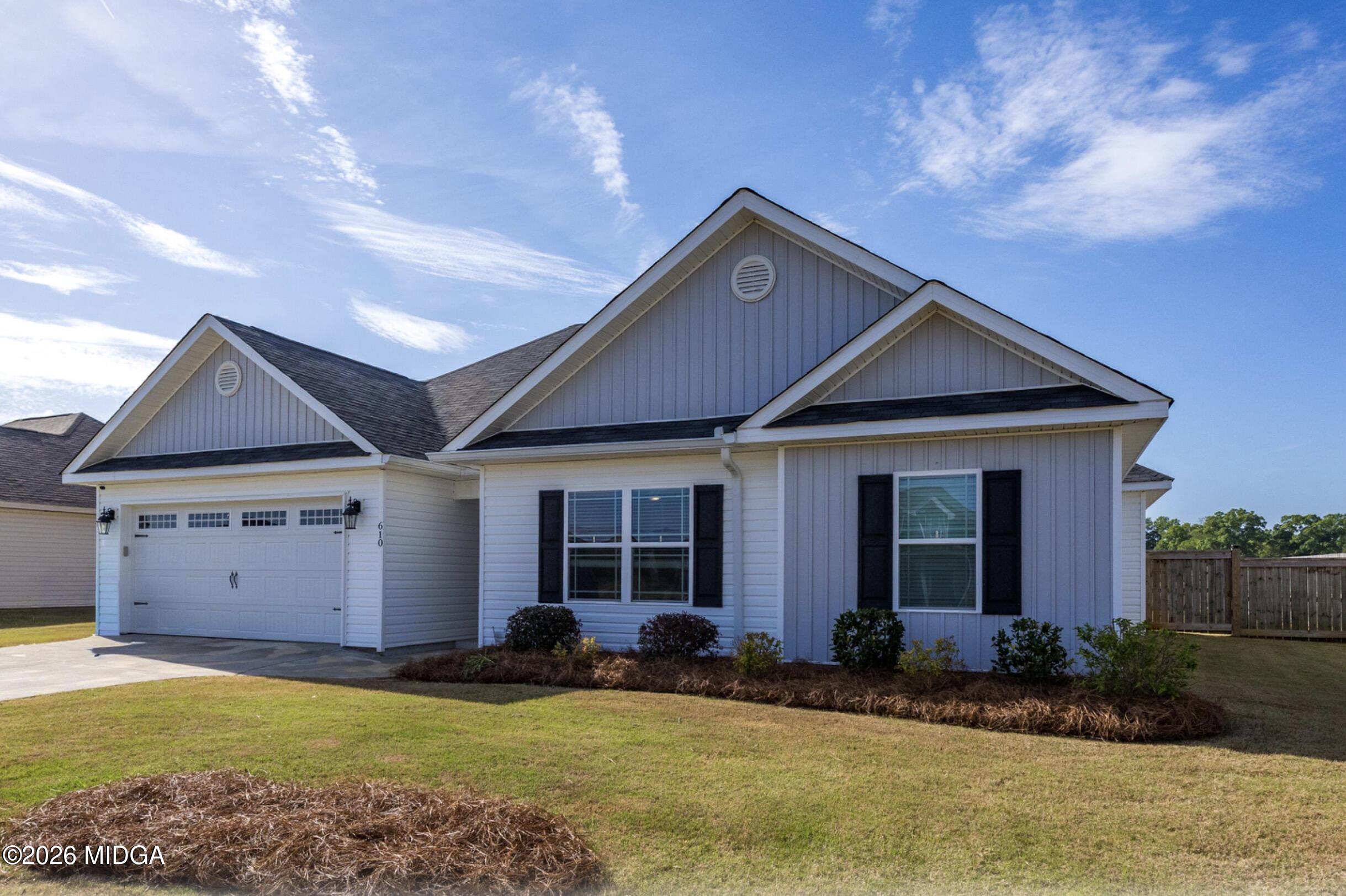 610 Daisy Drive Perry, GA 31069 - Photo 1 of 33 a front view of a house with a yard and garage