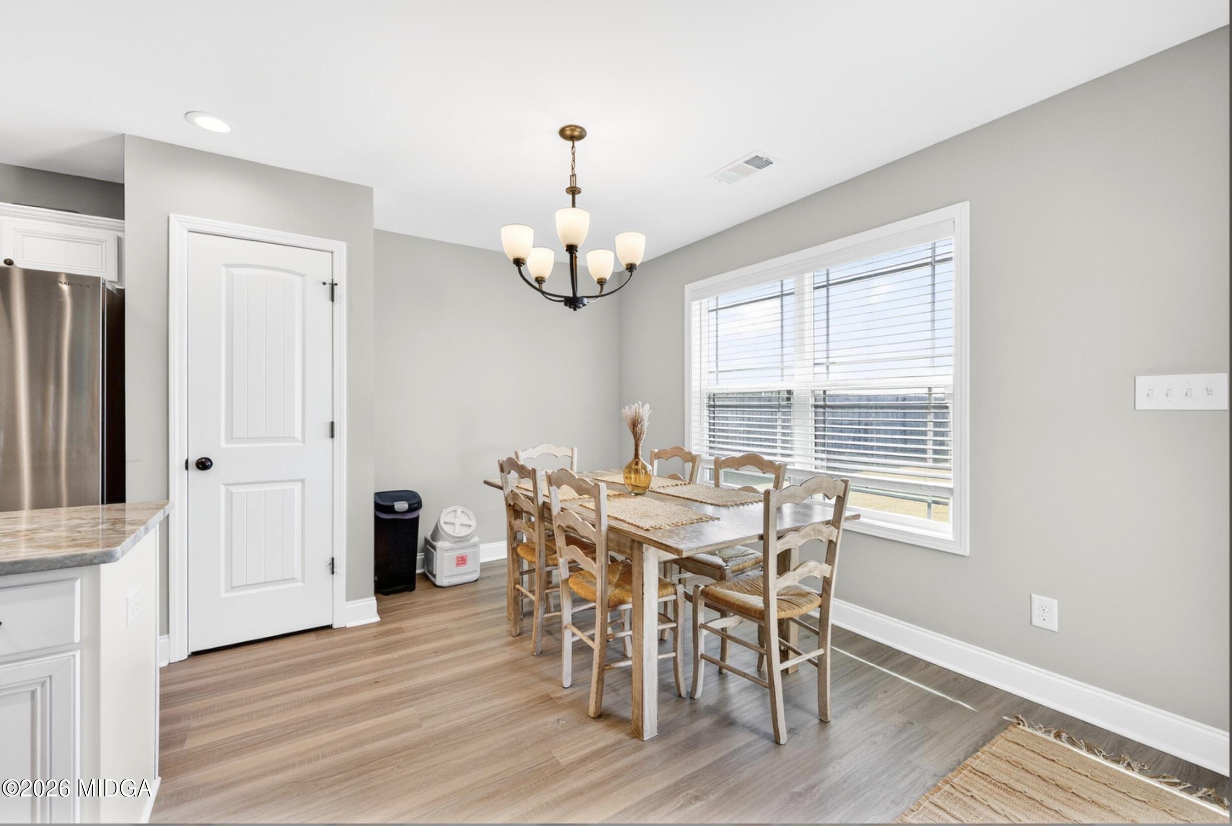 610 Daisy Drive Perry, GA 31069 - Photo 13 of 33 a view of a dining room with furniture wooden floor and chandelier